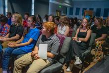 Image of attendees and students at the collegiate school commissioning ceremony