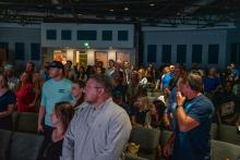 Image of attendees and students at the collegiate school commissioning ceremony