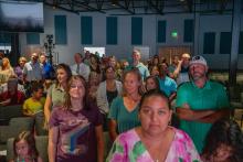 Image of attendees and students at the collegiate school commissioning ceremony