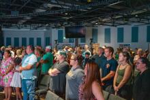 Image of attendees and students at the collegiate school commissioning ceremony